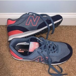 woman’s New Balance tennis shoes